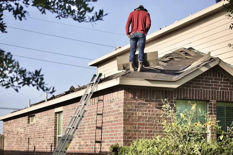 Professional roofer working on a residential roof in Steilacoom